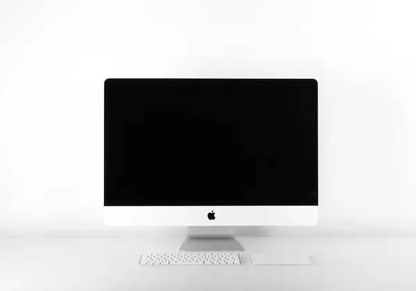 An all-in-one desktop computer on a plain desk